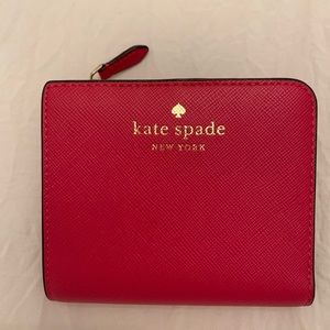 Kate Spade wallet. Billfold, change purse, outside window for ID. Palm-sized.
